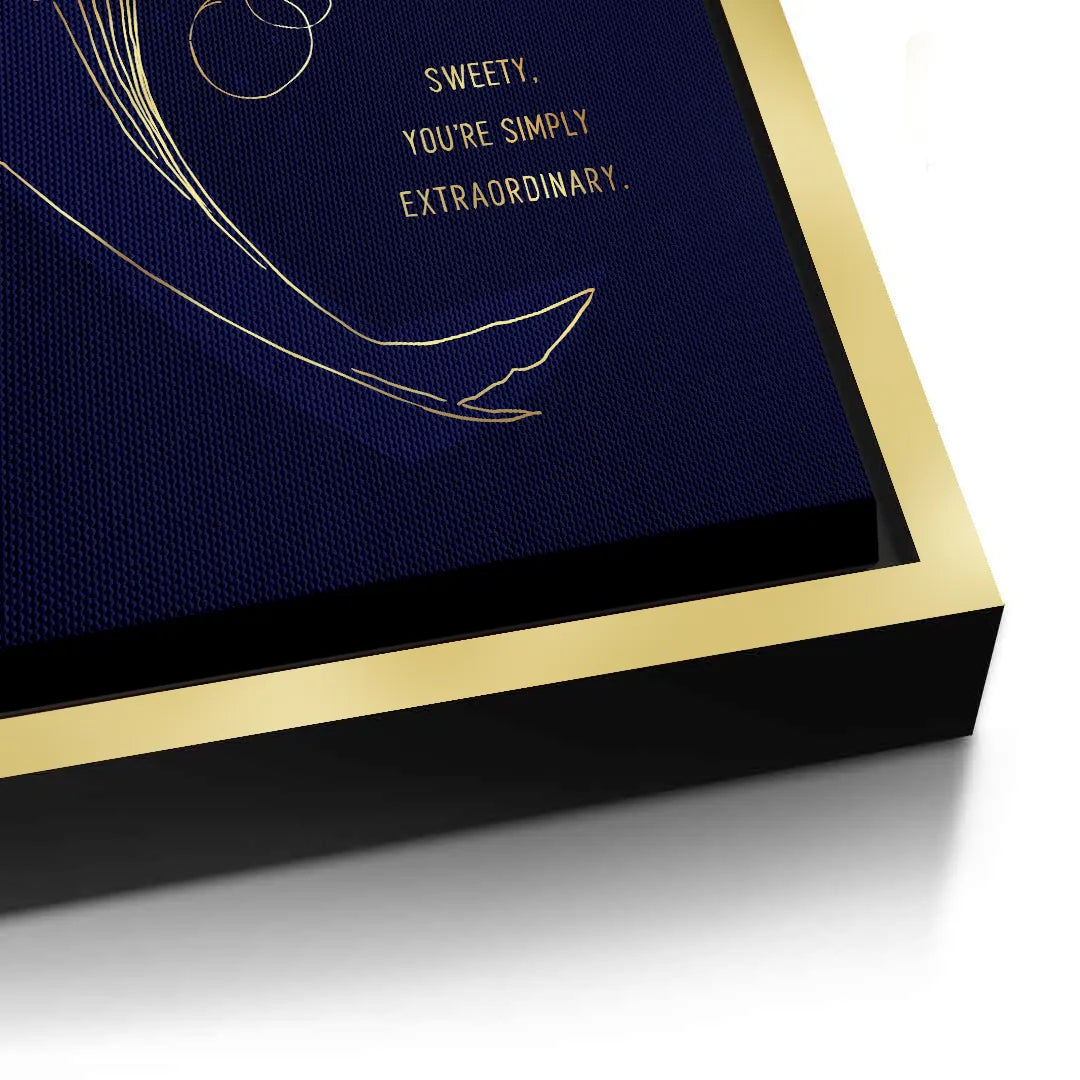 2Detailed view of the edge of a gold framed canvas print with gold line art whale on navy blue.