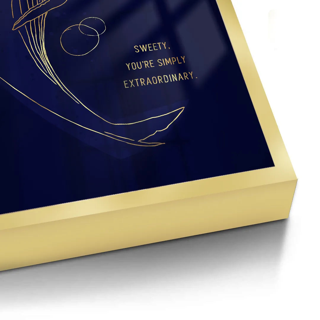 2Close-up corner detail of a gold framed fine art print with a gold line art whale on a navy blue background.