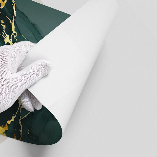 Hand in white glove peeling backing from dark green and gold marble abstract poster wall decal UAE Dubai