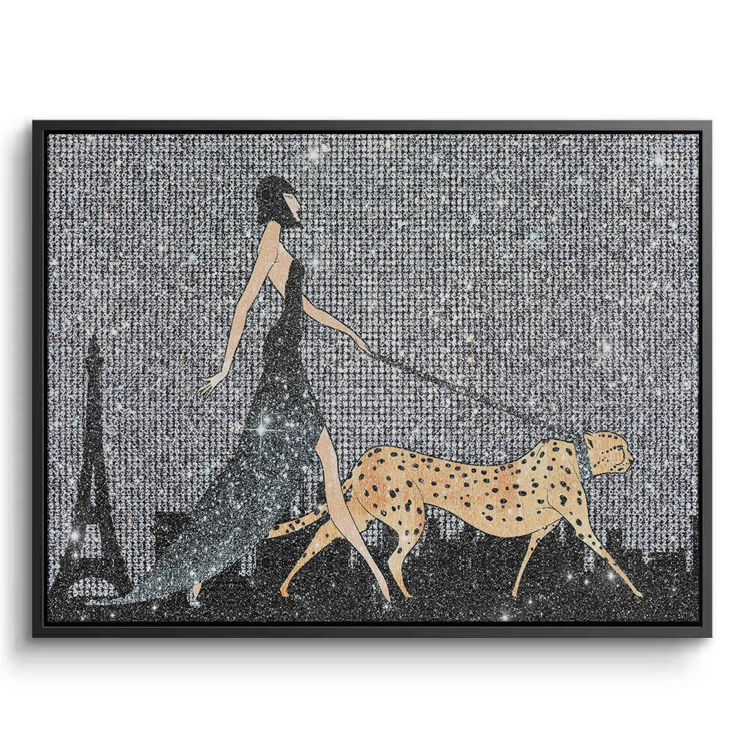 2Black framed canvas art of a woman in a long dress walking a cheetah with the Eiffel Tower in the background.