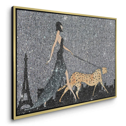 Angled view of the gold-framed woman and cheetah canvas print with a black and silver glitter design.