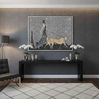 Modern interior with the woman and cheetah canvas art displayed over a black console table.