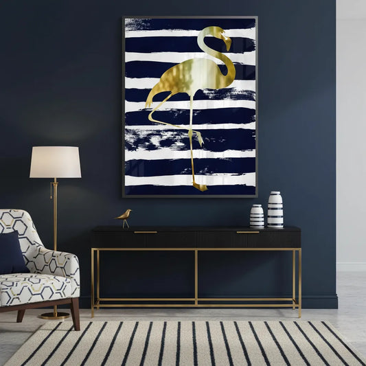Framed gold flamingo fine art print hanging above a console in a dark, nautical-inspired room.