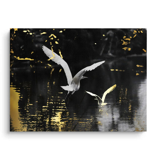 Gallery wrap canvas print of white birds flying over an abstract black and gold water surface.