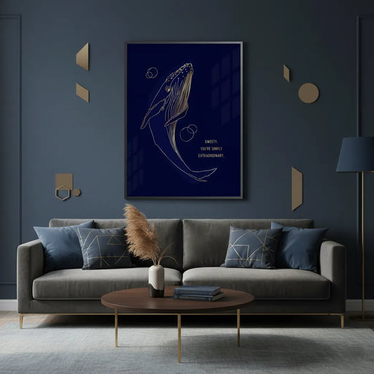 Fine art print of a gold line art whale in a minimalist living room with a dark blue wall and gray sofa.
