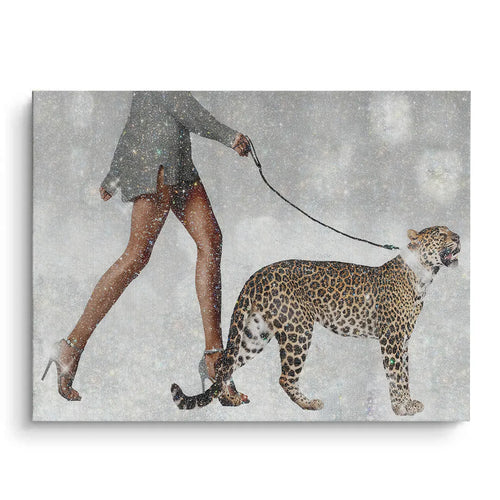 Large horizontal Canvas print of a woman walking a leopard on a leash in a snowy, glittery setting