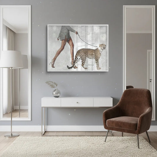 Framed Fine Art print of leopard and woman hanging above a white console table in a neutral room