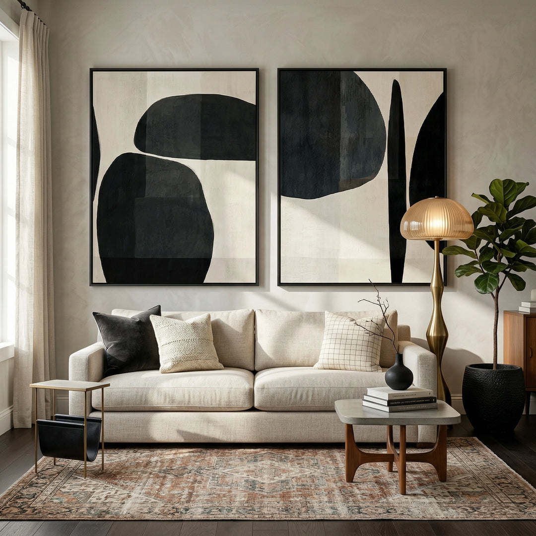 Minimalist 'Monochrome Organic Shapes' diptych with heavy hand-sculpted textures and soft shadow play, bringing architectural balance to a contemporary Abu Dhabi home.