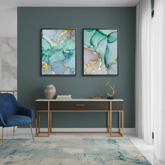 Modern living room with a set of two teal and gold abstract canvas prints in black frames above a wooden console table UAE Dubai.