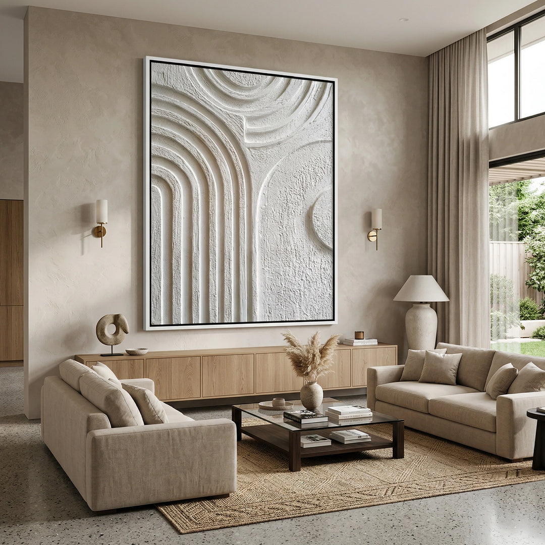 Arched wall mirror with a minimalist 'Organic Modern' frame in a cream travertine finish, an elegant focal point for a luxury Dubai hallway.