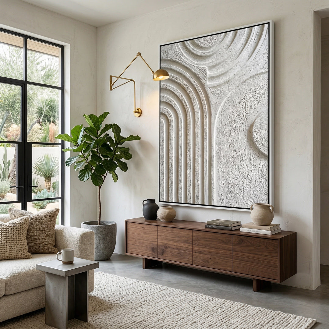 Arched wall mirror with a minimalist 'Organic Modern' frame in a cream travertine finish, an elegant focal point for a luxury Dubai hallway.
