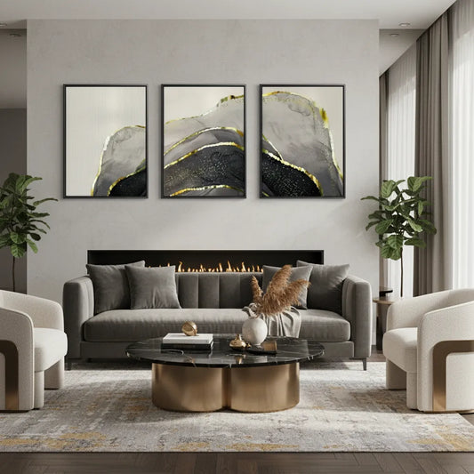 Modern living room with gray sofa, coffee table, and abstract wall art.