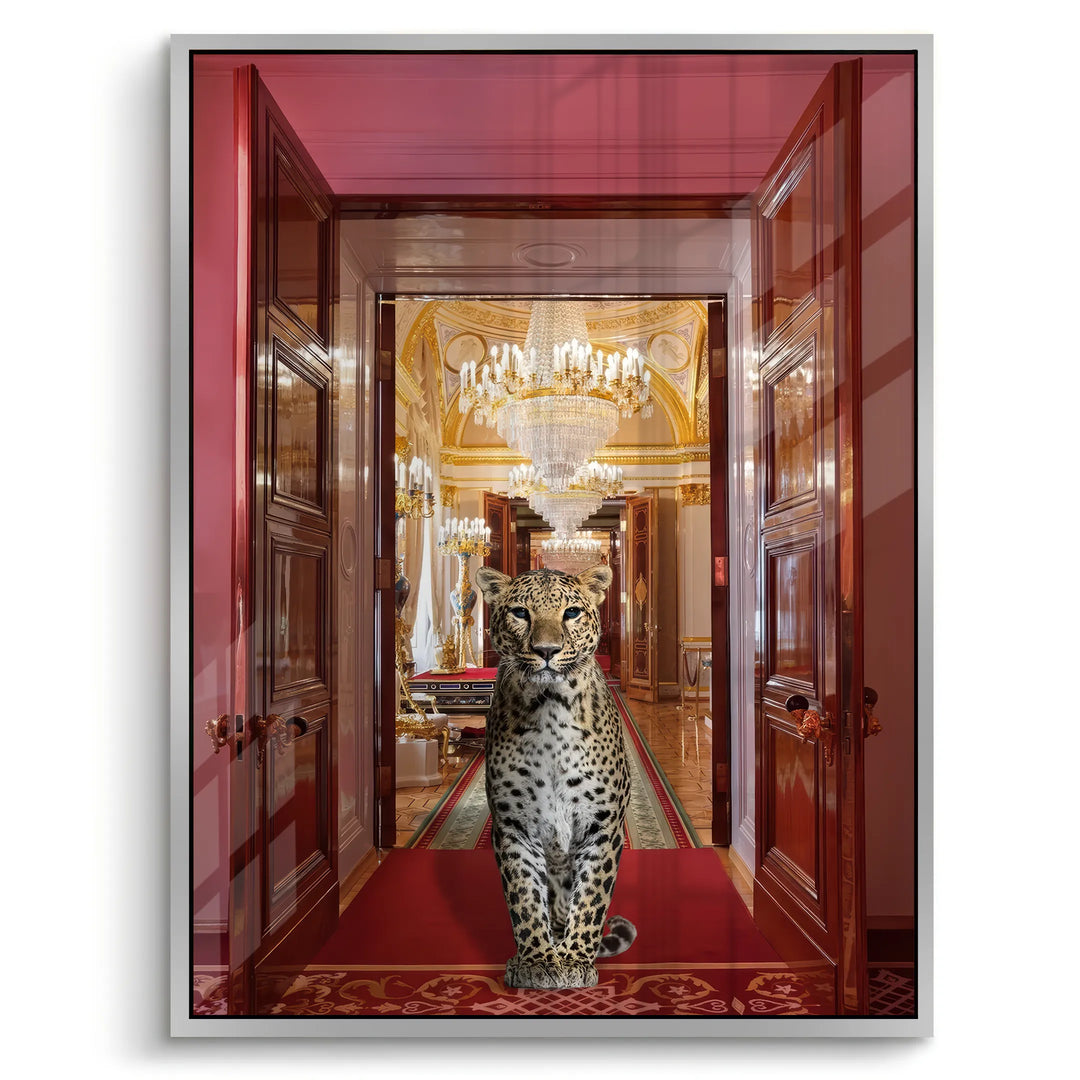 white framed, modern acrylic wall art of a leopard between grand red wooden doors in a gilded hall.