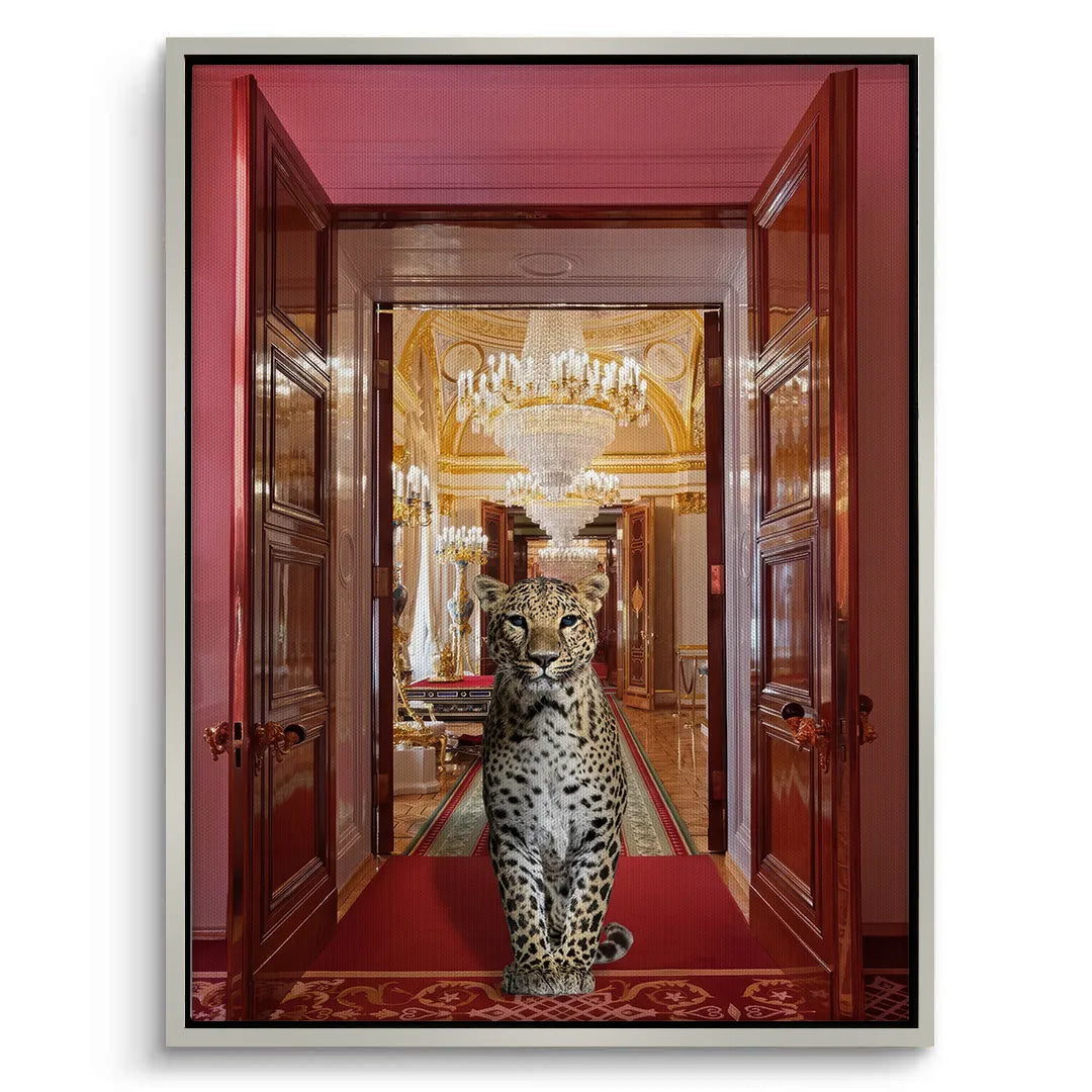 White-framed canvas art print of a leopard standing in a grand red and gold palace hall entryway.