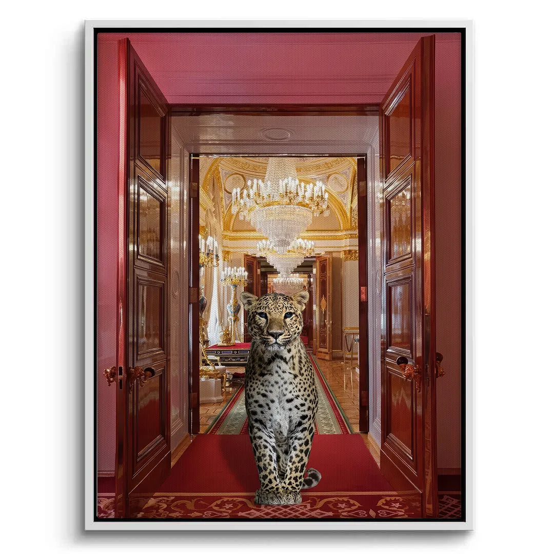 white-framed canvas print of a leopard on a red rug leading to a golden, chandeliered hall.