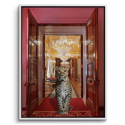 white-framed canvas print of a leopard on a red rug leading to a golden, chandeliered hall.
