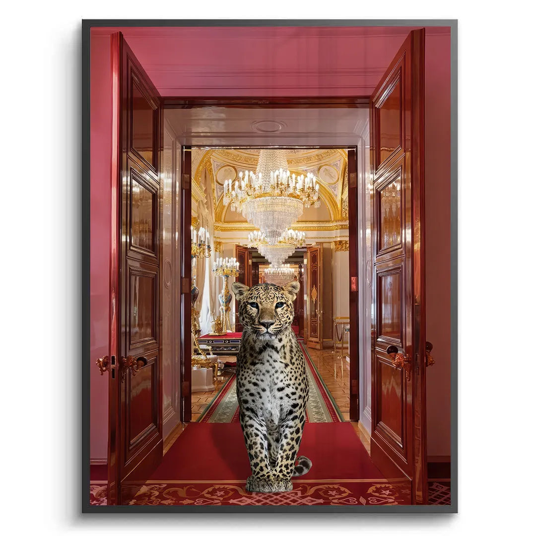 2Black-framed fine art print of a leopard on a red carpet leading to a golden, chandeliered palace hall.