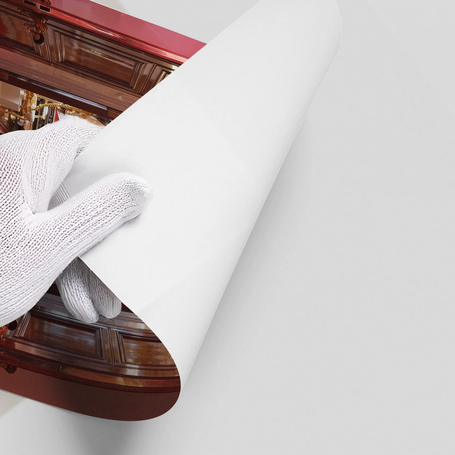 2Close-up of a hand in a white glove peeling back the edge of a glossy leopard in palace poster.