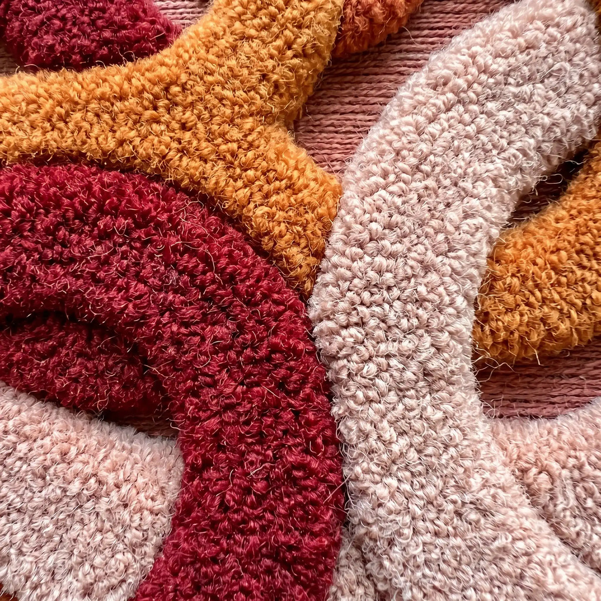Infinite Loops modern abstract rug in Berry Spice – close-up of the tufted pile texture