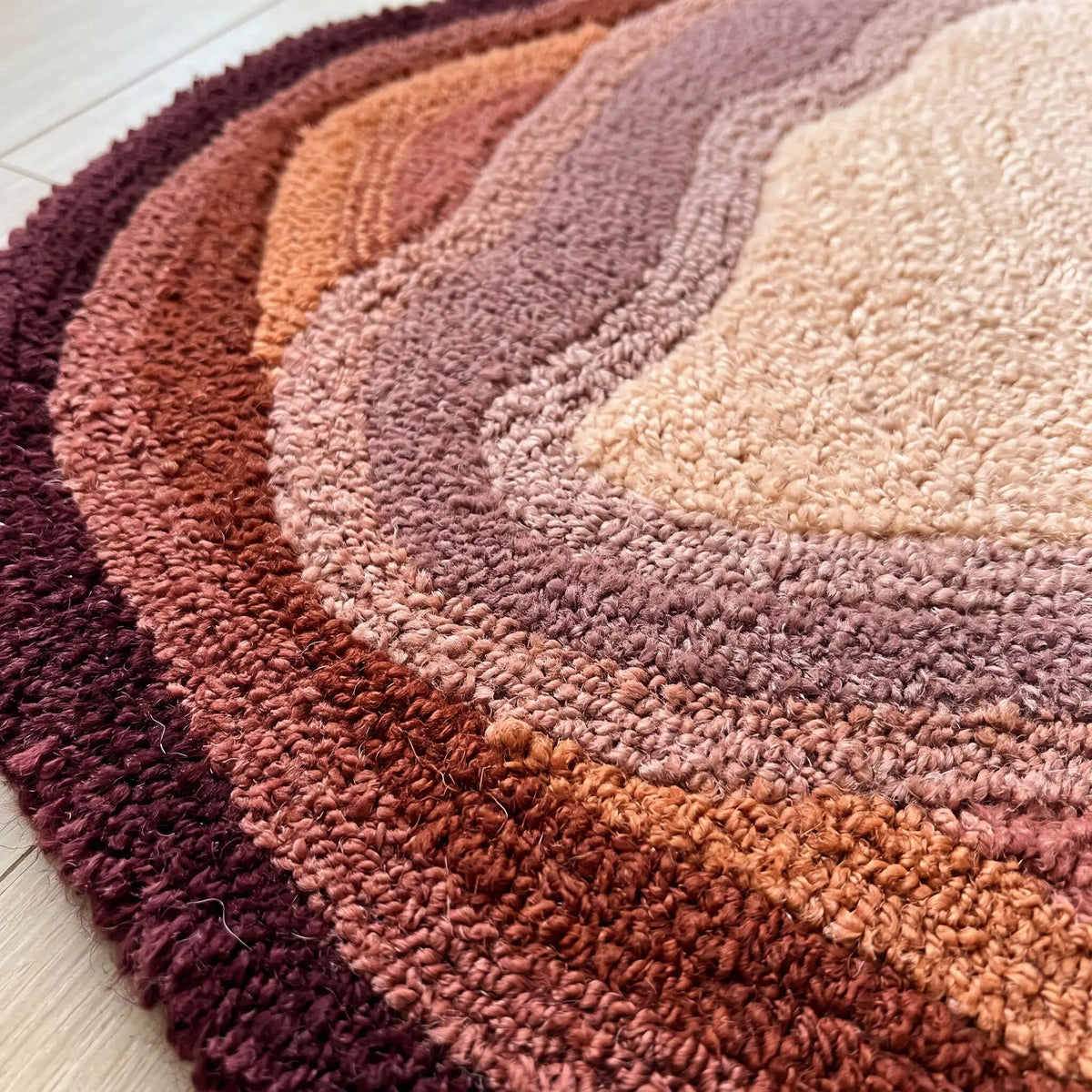 Stone Pool hand-tufted rug in Wine Peach – close-up of the tufted pile texture
