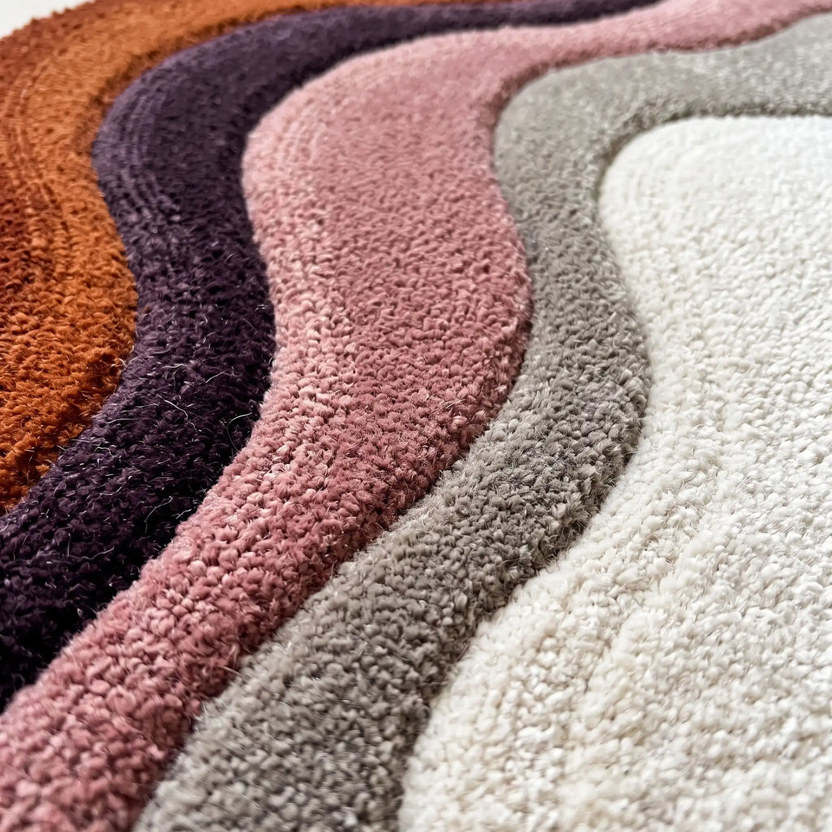 Echo Pool modern abstract rug in Rust Plum – close-up of the tufted pile texture